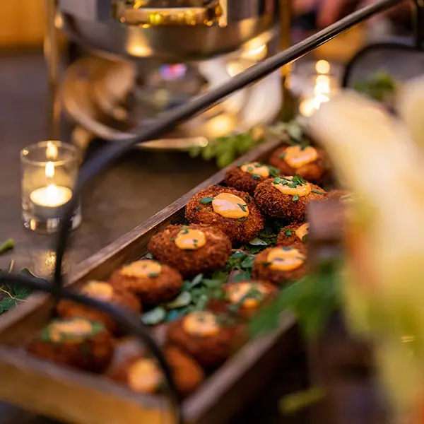 A picture of delicious looking crab cakes set out on a buffet table